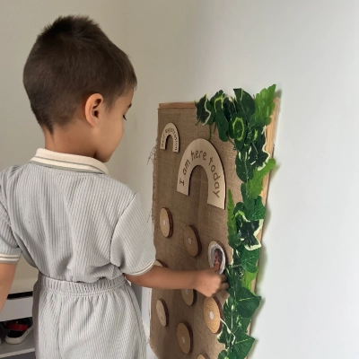 A child signing in at nursery.
