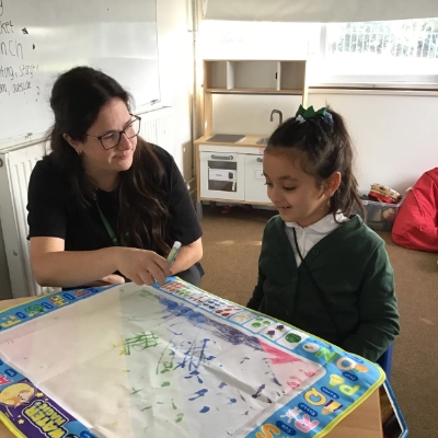 A child and teacher in a school classroom.