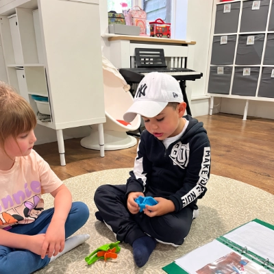 Two children in nursery playing with a marble run.