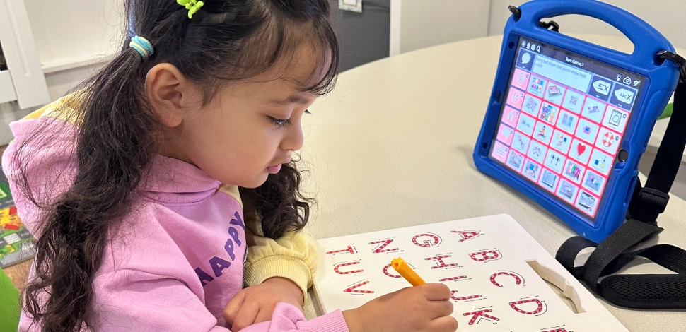 A child in nursery learning the alphabet.