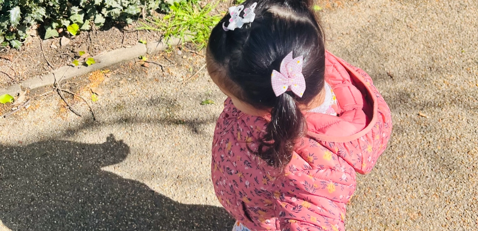 A young girl walking outside.